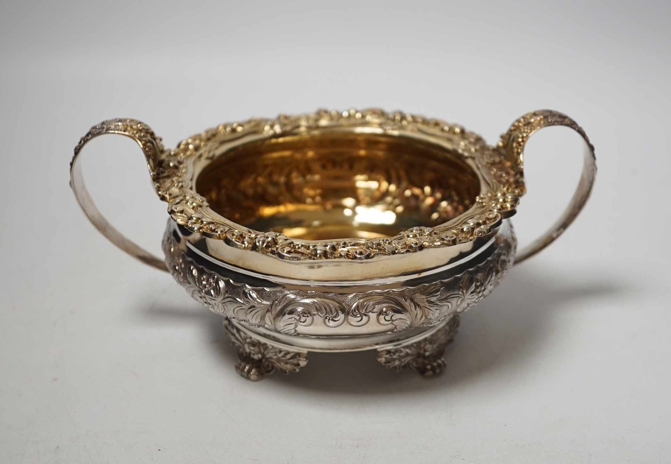 A George IV embossed silver two handled sugar bowl, Thomas James, London, 1822, diameter 14.7cm, 12.7oz.